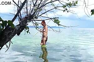 Topless babe spears fish with hidden harpoon thrills