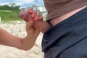 a milf jerks off stranger on public beach for hot bet cumshot