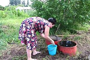 Mature housewife enjoys cucumber play in garden then returns home