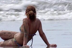 On the beach stepmother shows off her tits and pussy to stepsons friends